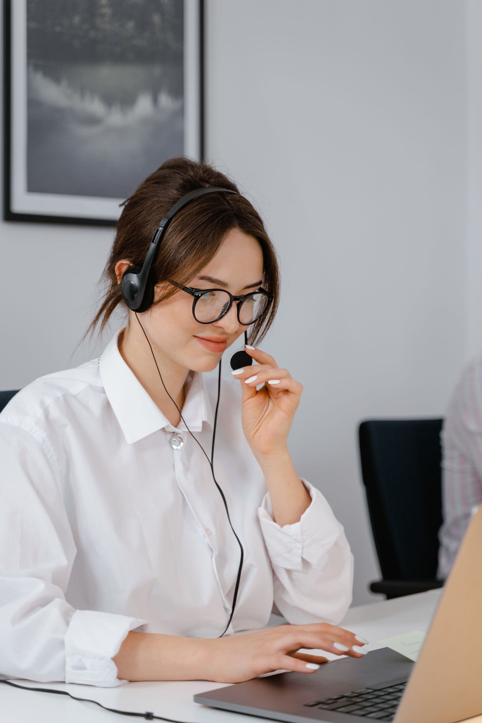 Phone support professional working from a laptop and headset