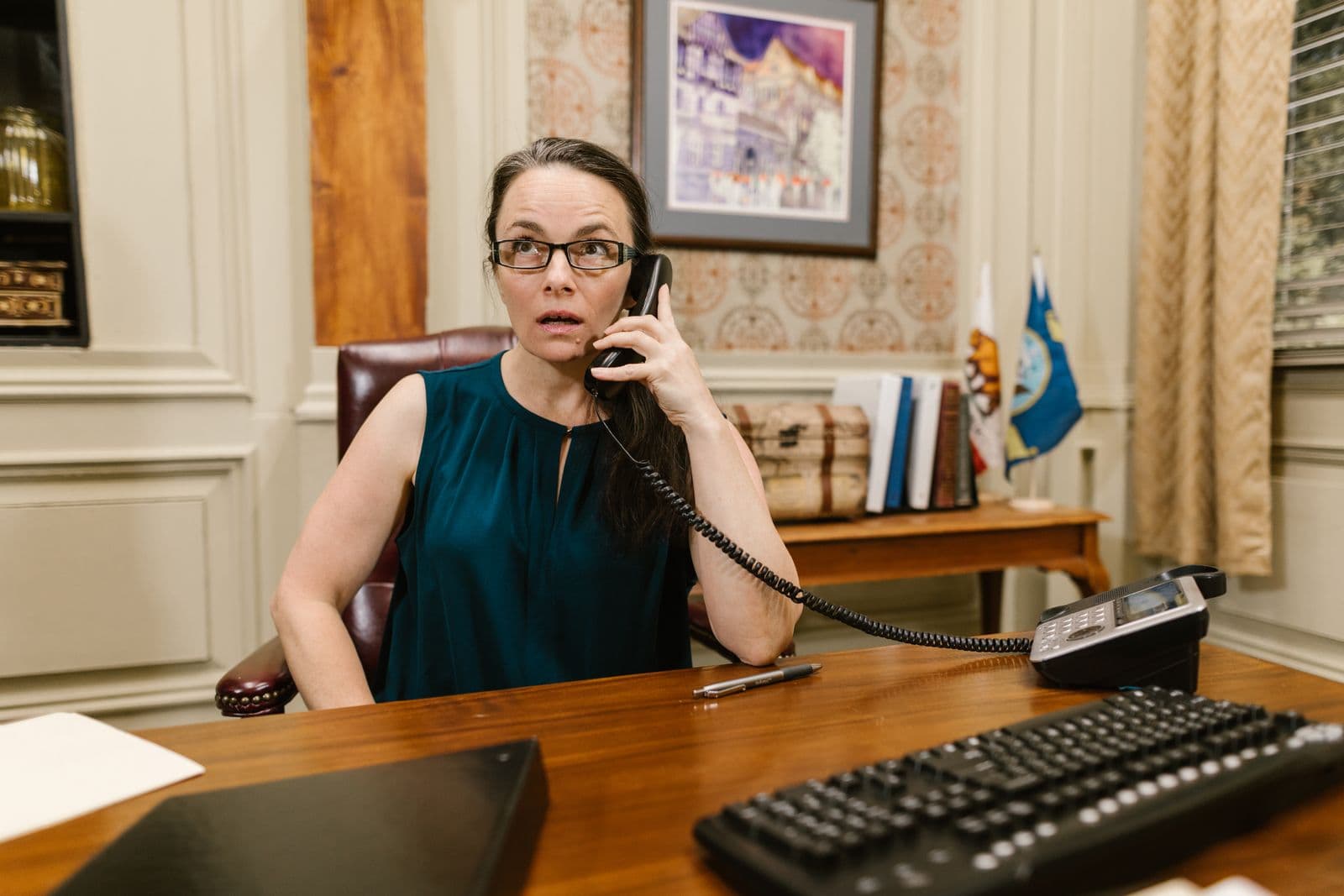 Reception professional answering a landline at an office desk